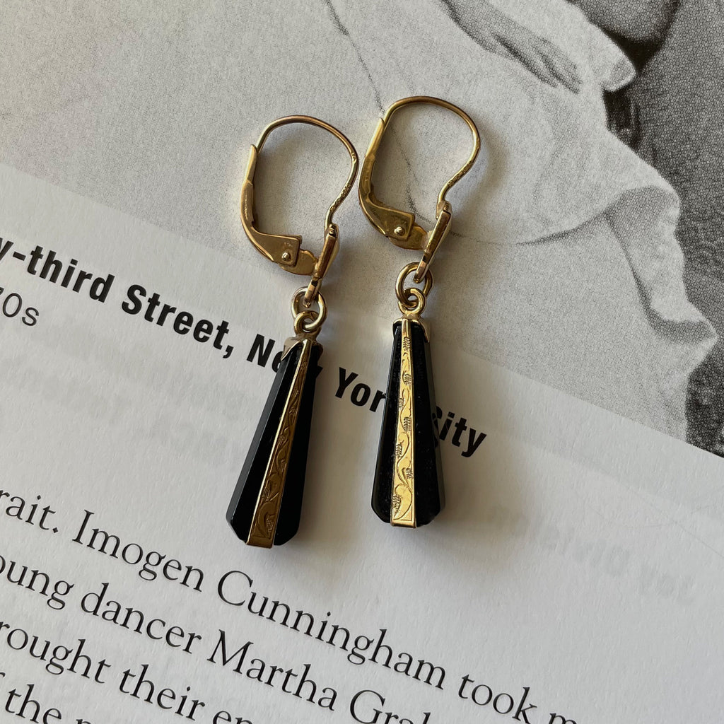 black and gold earrings in an engraved style.