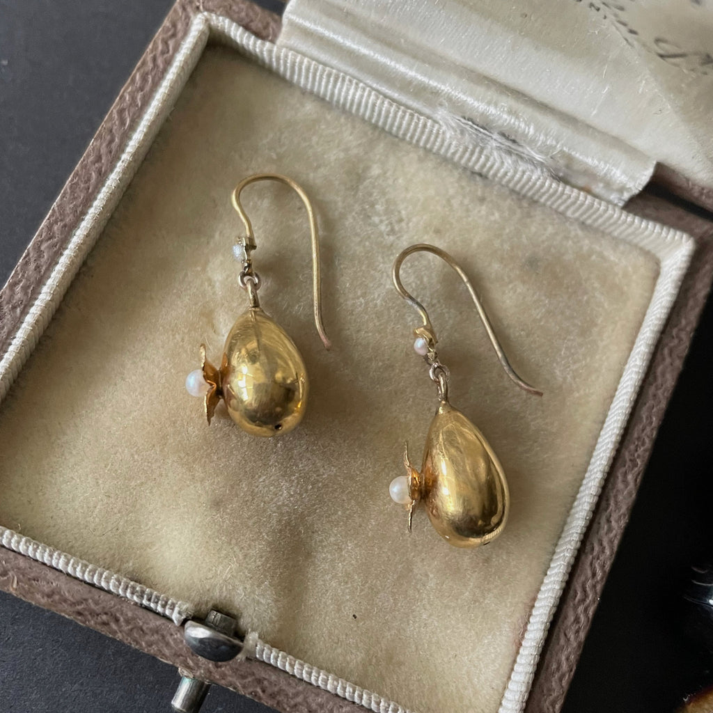 Gold drop earrings with pearls in an antique jewellery box.