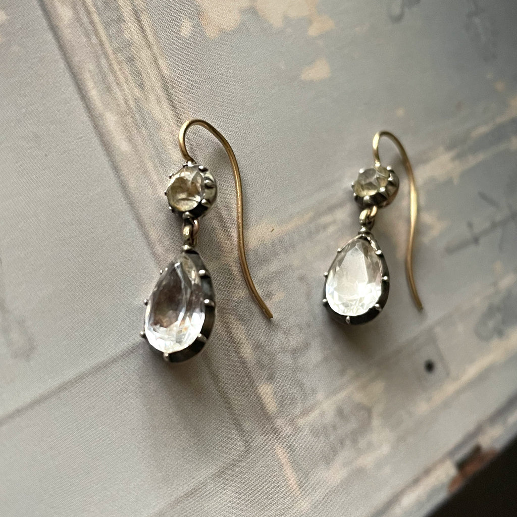 Drop earrings made of white paste and silver and gold settings.