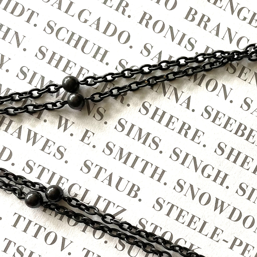Detail of a gunmetal long guard chain on book.