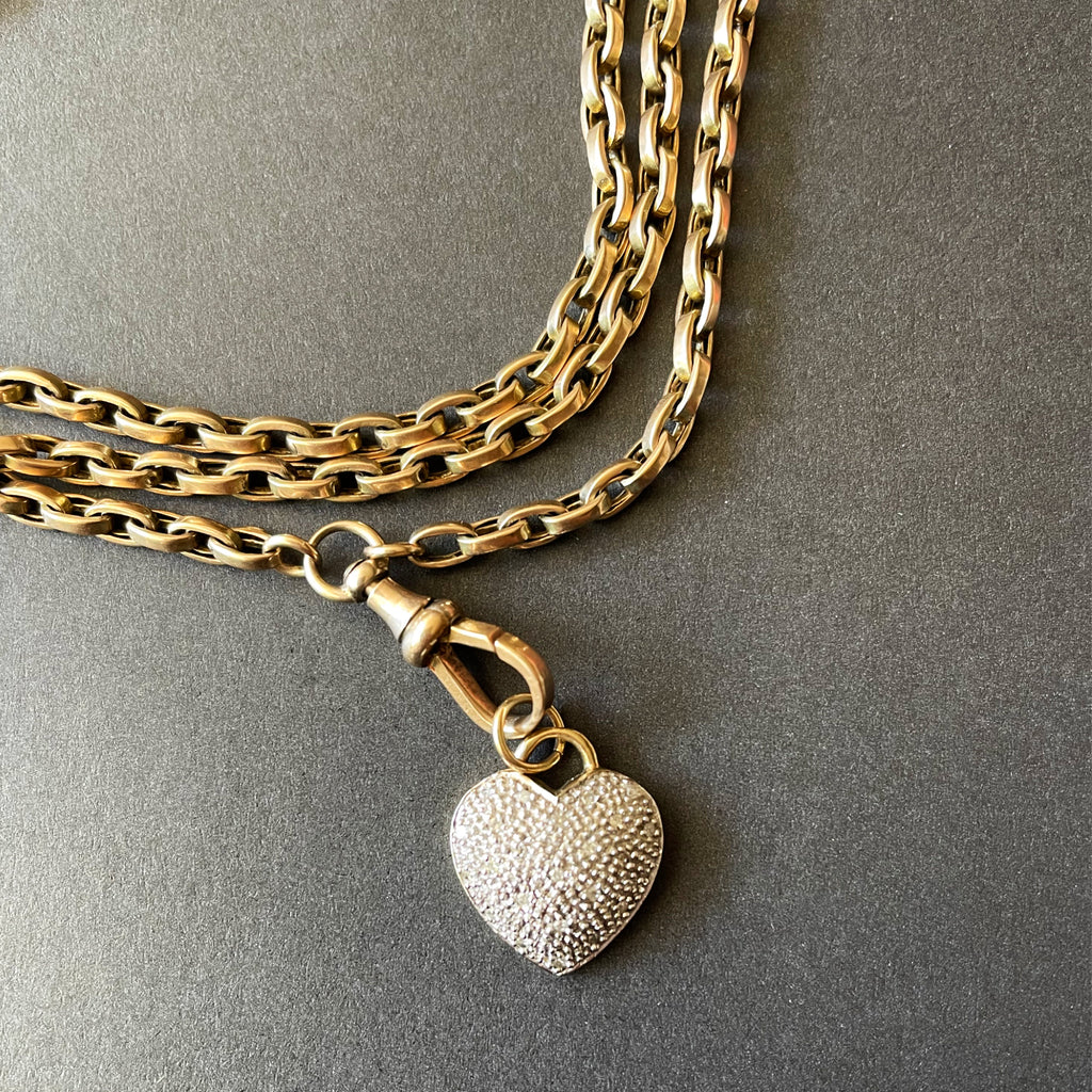 Diamond heart pendant on a thick gold chain with a swivel clasp.