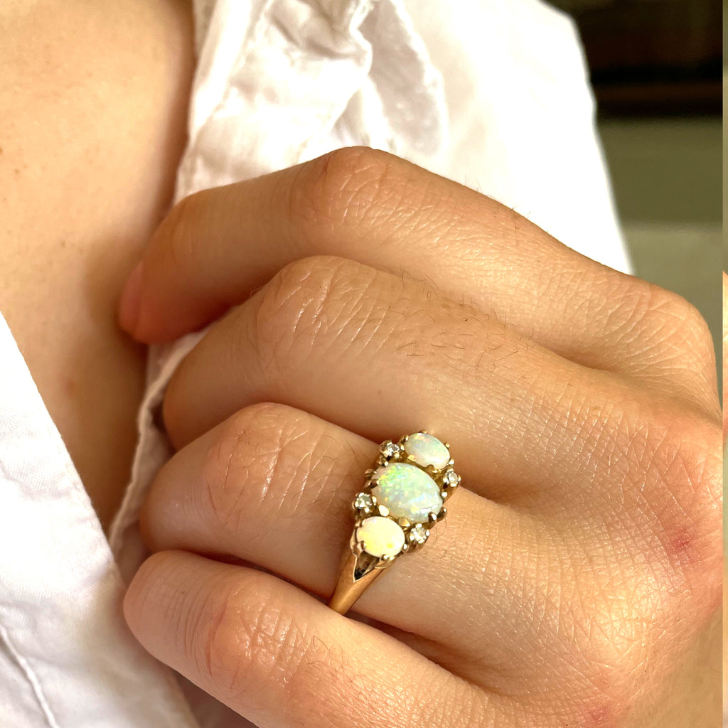 A vibrant ring of opals and diamonds in yellow gold.