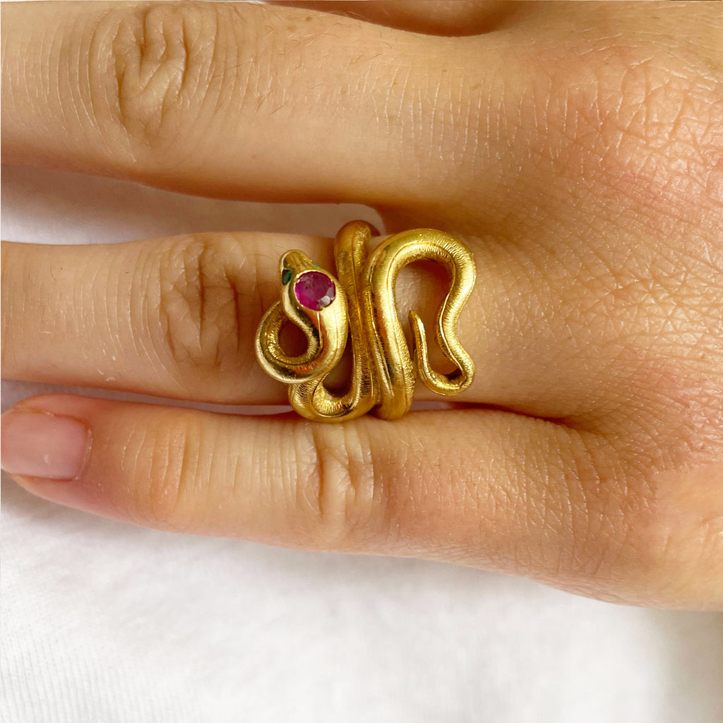 Large gold snake ring with ruby head and emerald eyes.