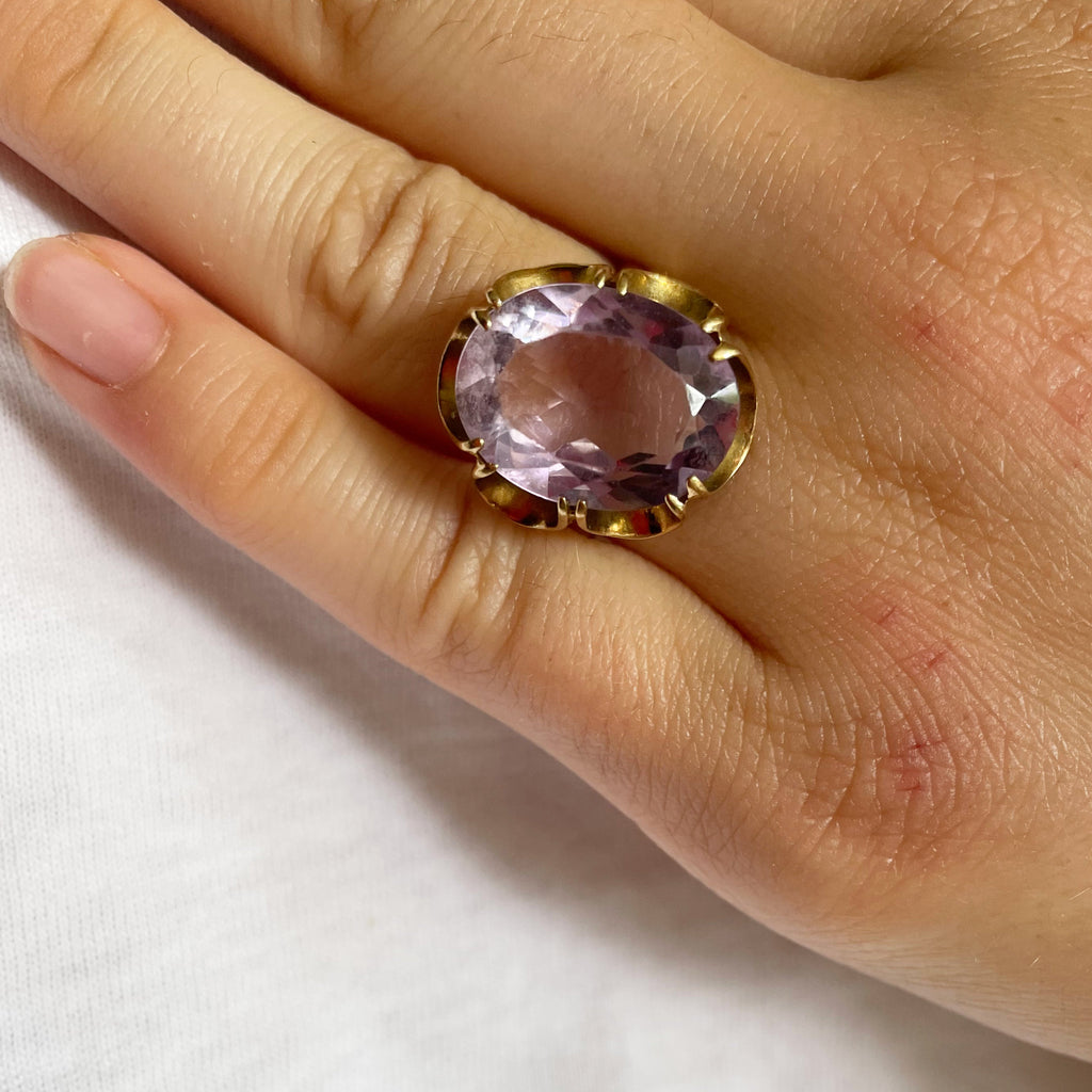 Large amethyst on scalloped gold shank and gold band.