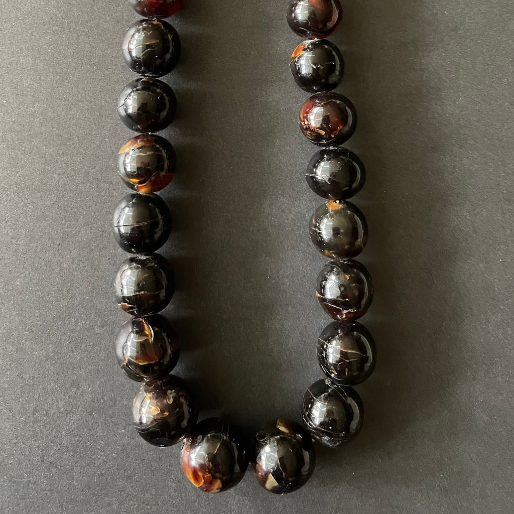 Detail of tortoiseshell beads on necklace.