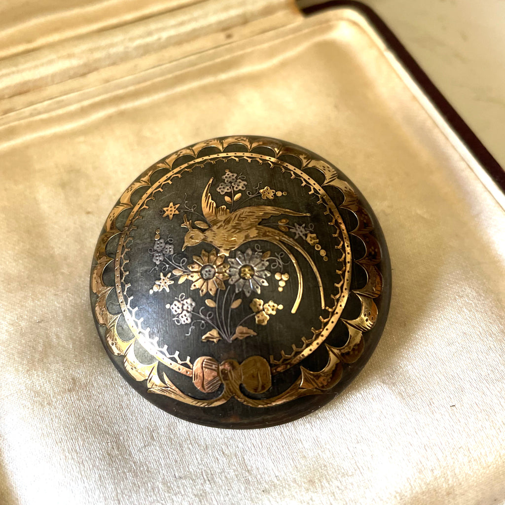 Antique pique brooch of tortoiseshell, gold and silver in an antique silk jewellery box.