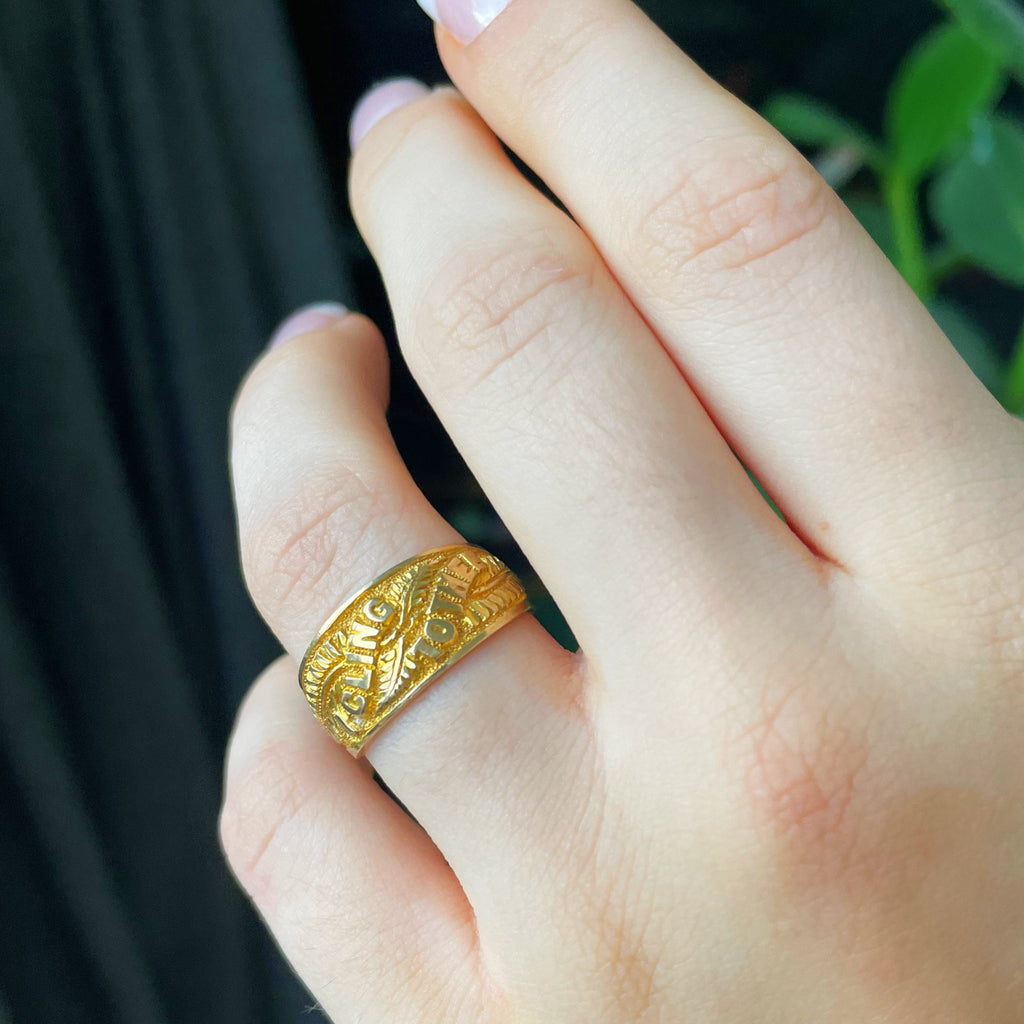 Gold ring with engraved message.