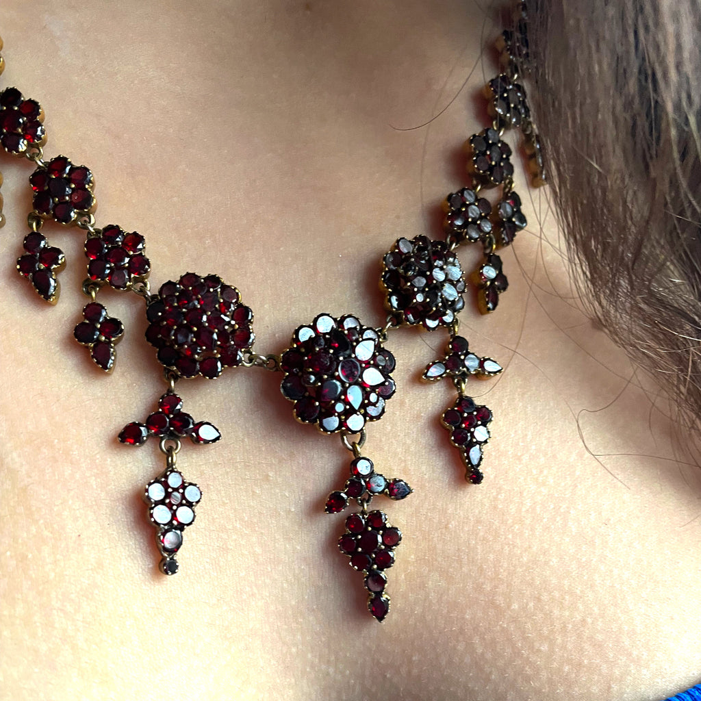garnet drop necklace on woman with brown hair