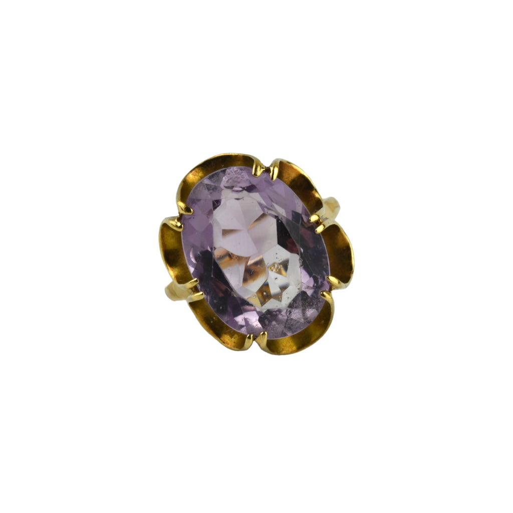 Large amethyst ring on gold detailed band.