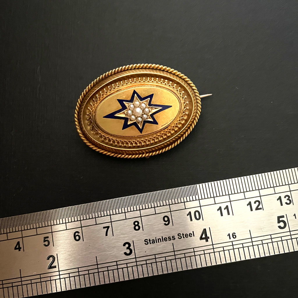 Gold locket next to steel ruler on black background